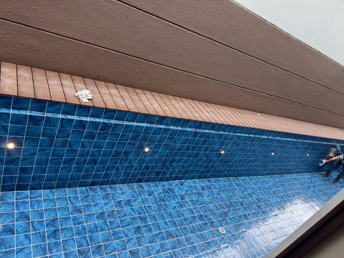 Completed underwater lighting installation illuminating the tiled swimming pool at a Singapore landed property